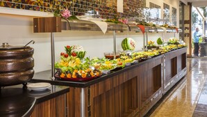 A buffet with various food items and a decorative wall with colorful tiles. - Kleopatra Ada Beach Hotel (Alanya)