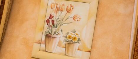 Un tableau encadré représentant des fleurs dans des pots.