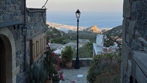 A stone staircase leading to a balcony overlooking a coastal landscape. - Diktynna Luxury Villas (Ierapetra)