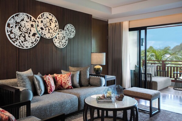 A modern living room with a sofa, coffee table, and a balcony with outdoor furniture. - Phuket Marriott Resort and Spa, Nai Yang Beach (Sa Khu)
