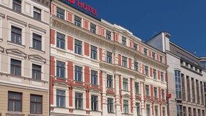 A multi-story hotel with a prominent "ibis HOTEL" sign.