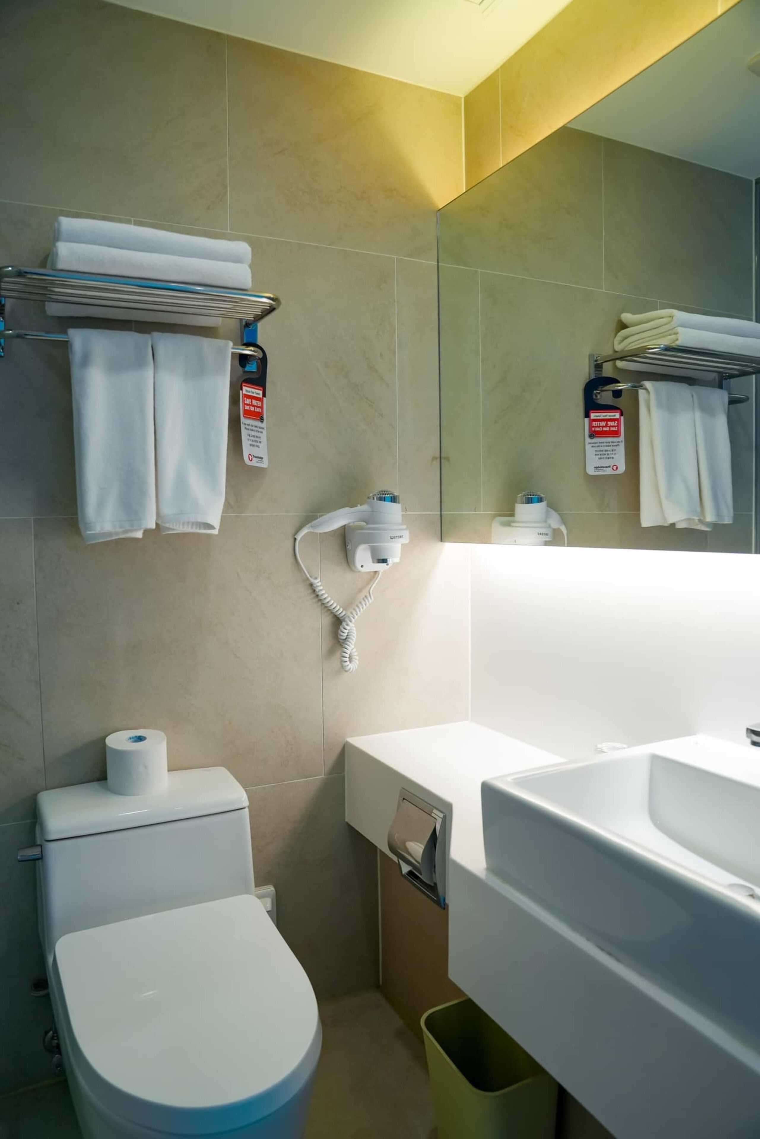 shower, hair dryer, slippers, towels