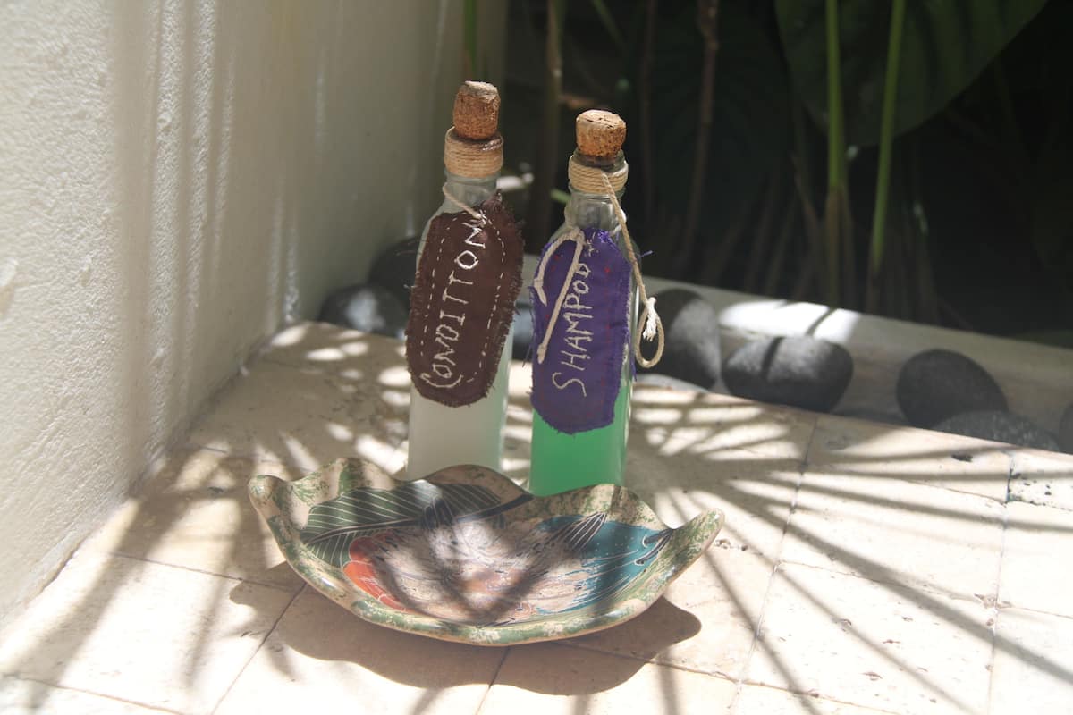 Two bottles labeled 'Condoms' and 'Shampoo' on a decorative dish.