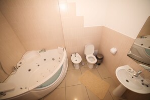 Junior Suite, Jetted Tub | Bathroom | Free toiletries, slippers, towels
