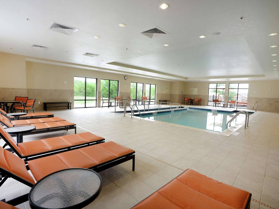 A pool area with sun loungers and a pool table.
