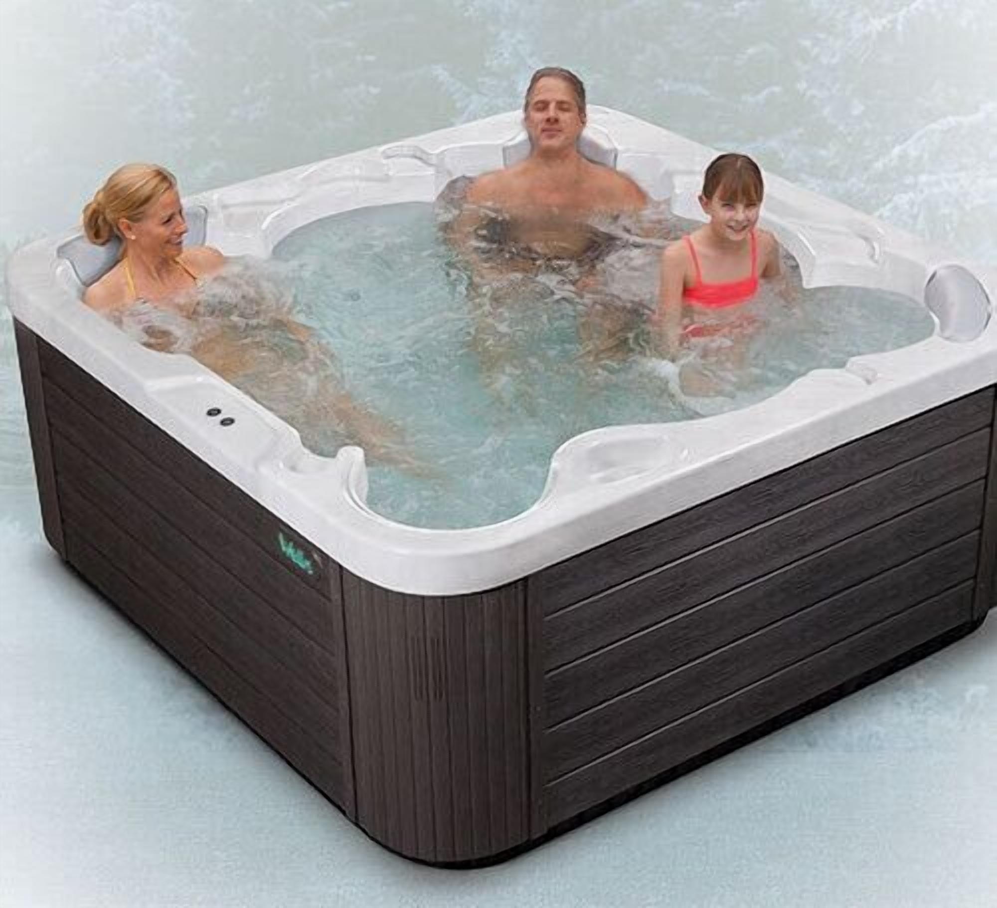 A hot tub with three people in it.