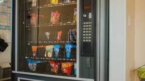 A vending machine with various snack options. - Bama Inn (Huntsville)