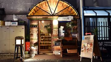 A restaurant with a wooden facade and a signboard displaying the menu.