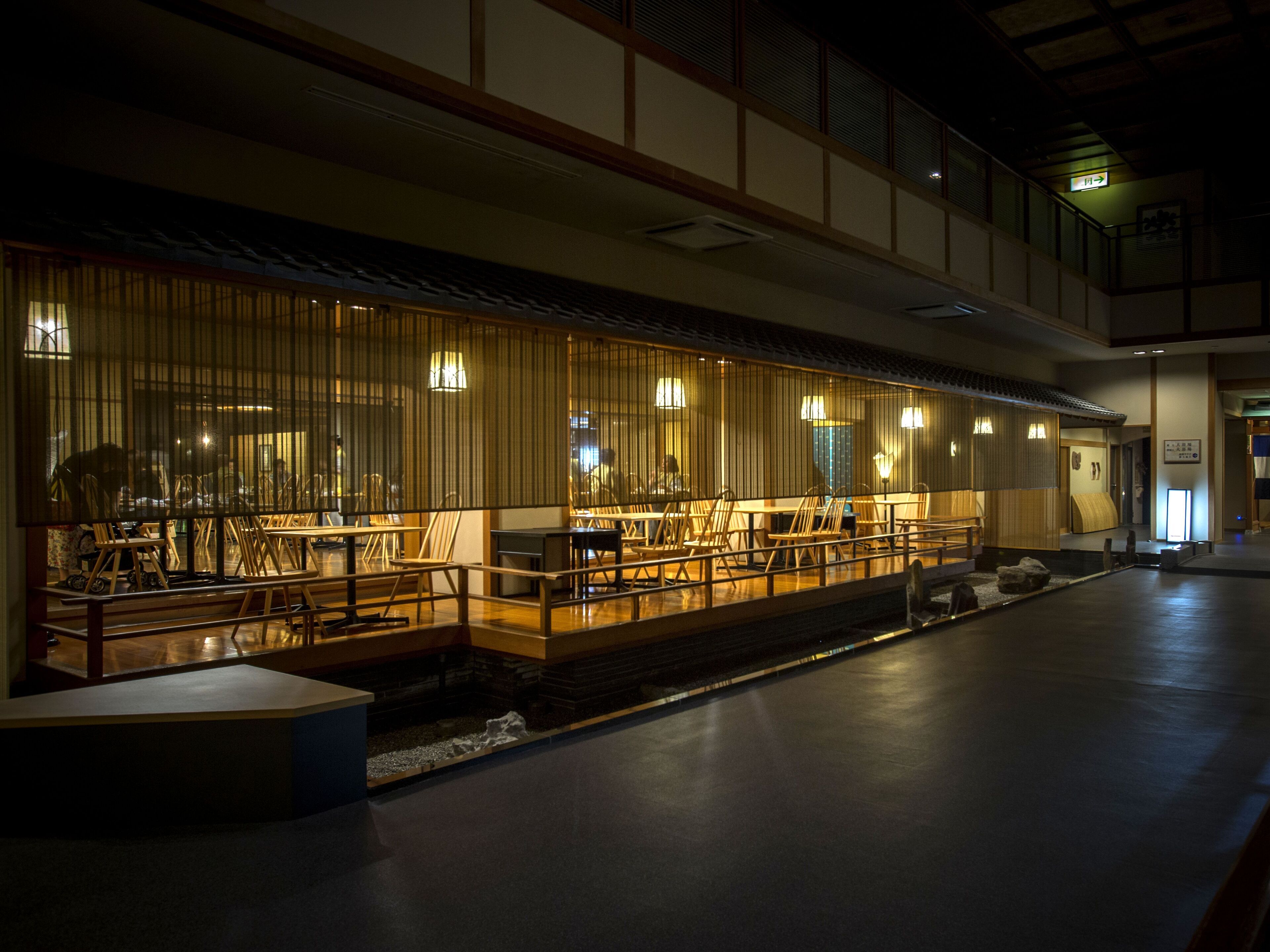 A traditional Japanese restaurant with wooden interiors and a low seating area.