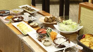 A buffet table with various dishes and condiments.