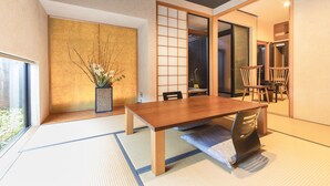 A traditional Japanese-style room with tatami flooring, a wooden dining table, and sliding doors. - Yushintei (Hakone)