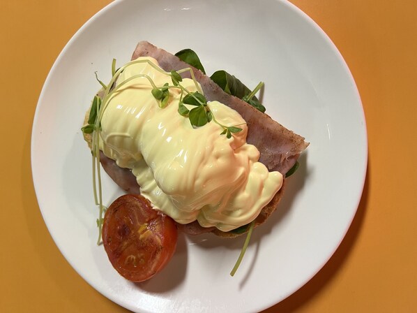 A plate with a sandwich, a slice of tomato, and some greens. - George Hotel Brisbane, Independent Collection by EVT (Brisbane)