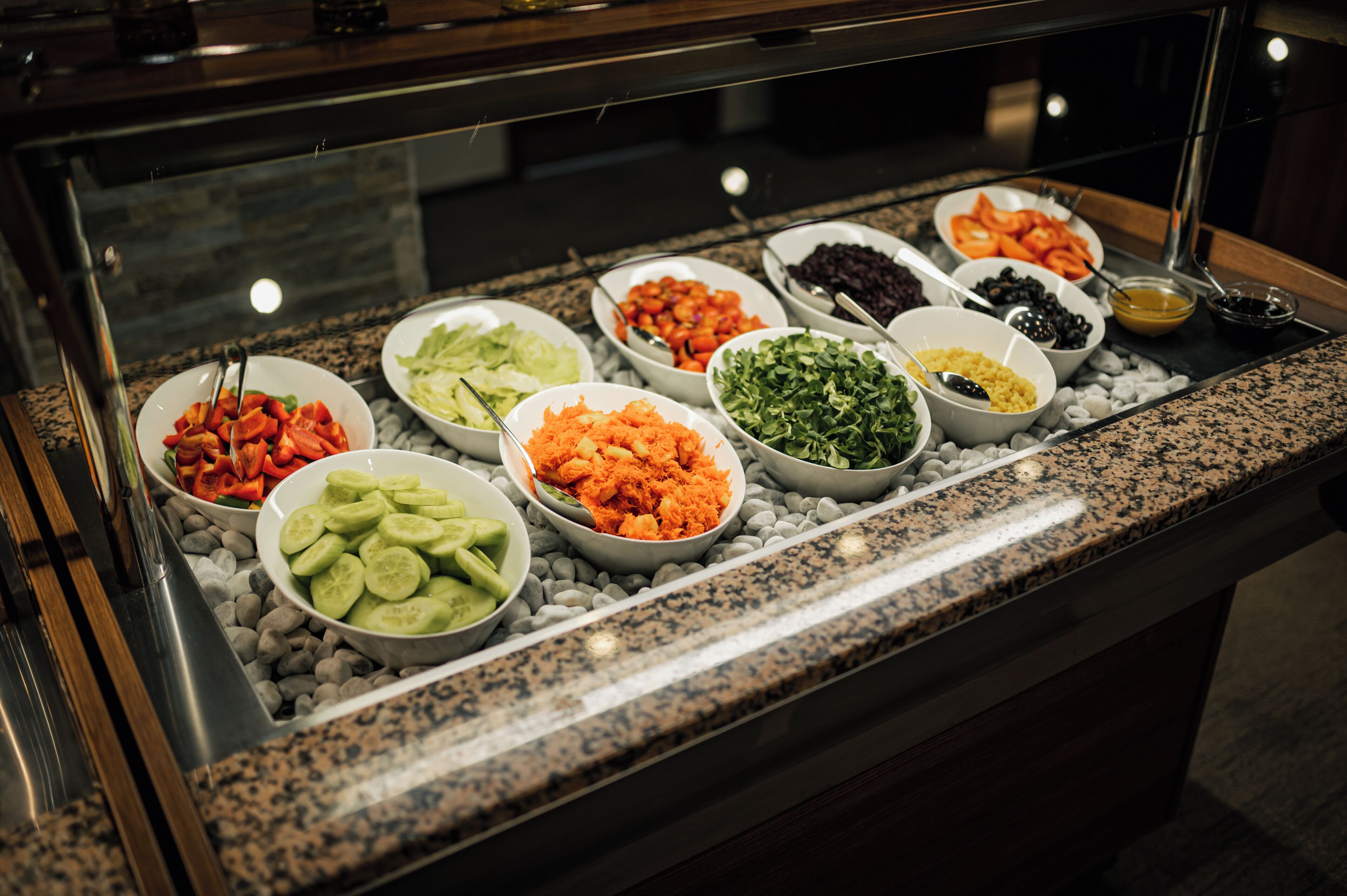 A buffet with various food items displayed in bowls.