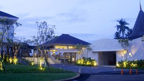 A modern building with a flat roof, a covered outdoor area, and a landscaped garden with trees and shrubs. - Putri Duyung Ancol (Jakarta)