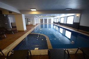 Una piscina techada, sillones reclinables de piscina