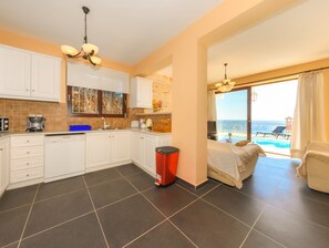 Full-size fridge, stovetop, dishwasher, coffee/tea maker