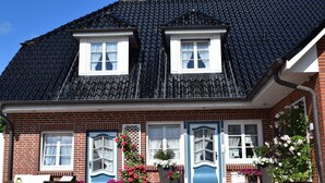 A two-story house with a dark tiled roof, white-framed windows, and a brick facade. - Freie Sicht Das Nordsee-Gesundheitshaus 1 (Dagebuell)
