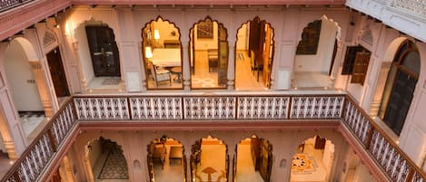 A multi-level courtyard with ornate railings and traditional architecture.