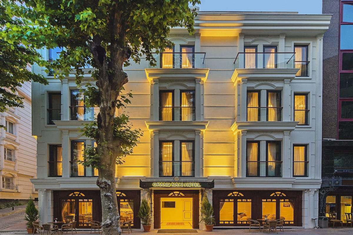 A grand hotel with a classic facade, multiple windows, and a welcoming entrance.