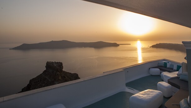 A sunlit balcony with a view of the sea and distant islands. - Andronikos Santorini (Santorini)