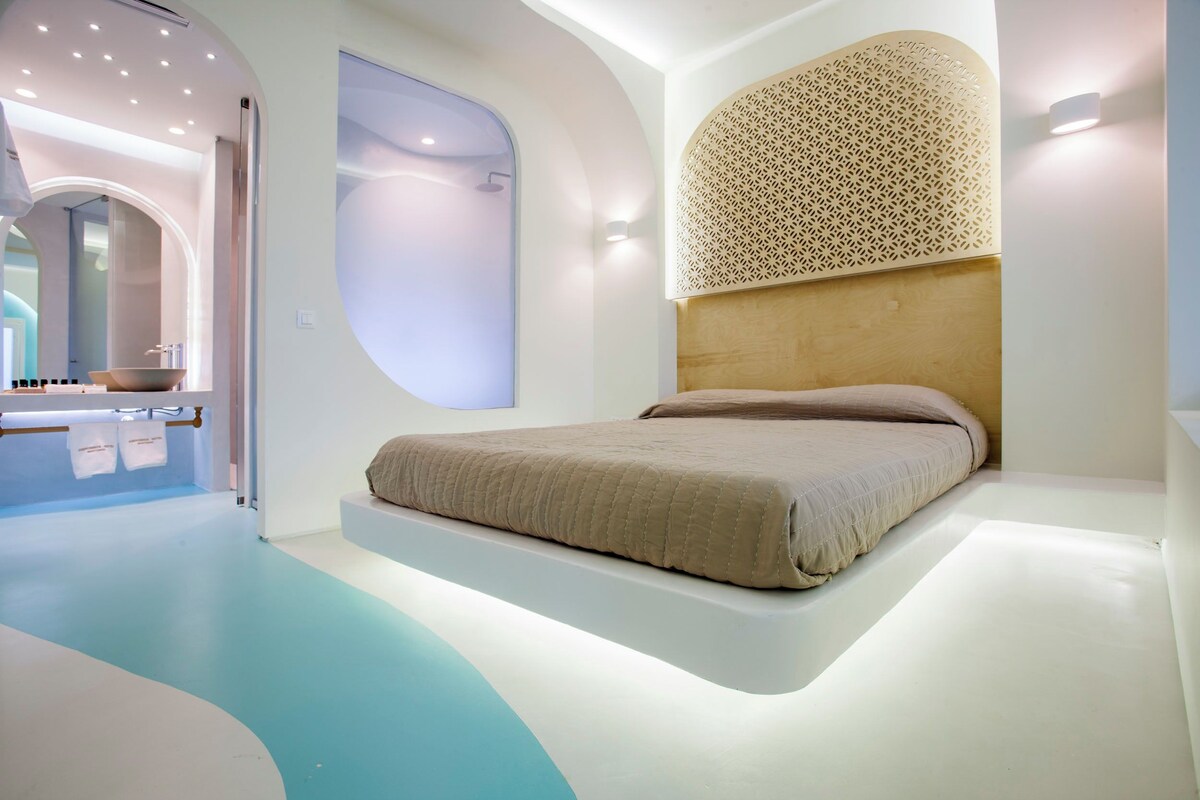A modern bedroom with a floating bed, a large mirror, and a unique wall design.