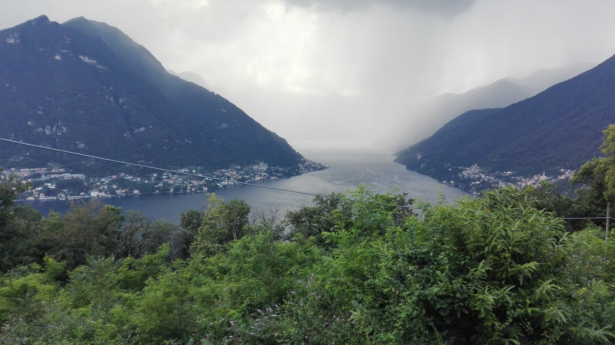 A mountainous landscape with a bridge spanning a valley.