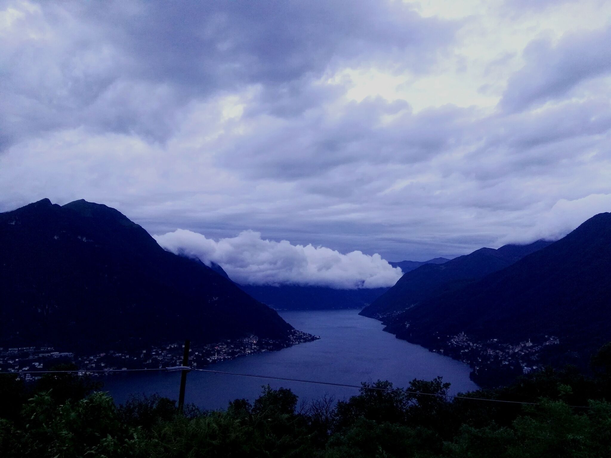 A mountainous landscape with a lake and a town in the valley.