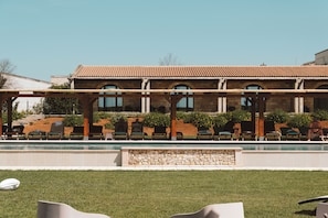 Seasonal outdoor pool, open 8:00 AM to 7:00 PM, pool umbrellas