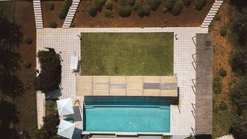 Seasonal outdoor pool, open 8:00 AM to 7:00 PM, pool umbrellas