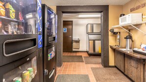 A compact kitchen with a refrigerator, microwave, and coffee maker. - Value Inn Kenosha I-94 - Exit 344 (Kenosha)