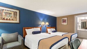 A hotel room with two beds, a sofa, a desk, and a bathroom visible through an open door. - Value Inn Kenosha I-94 - Exit 344 (Kenosha)