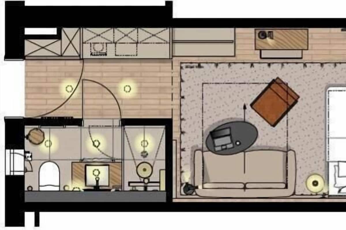 Distribución de una habitación de hotel con cama, zona de estar y una pequeña kitchenette.