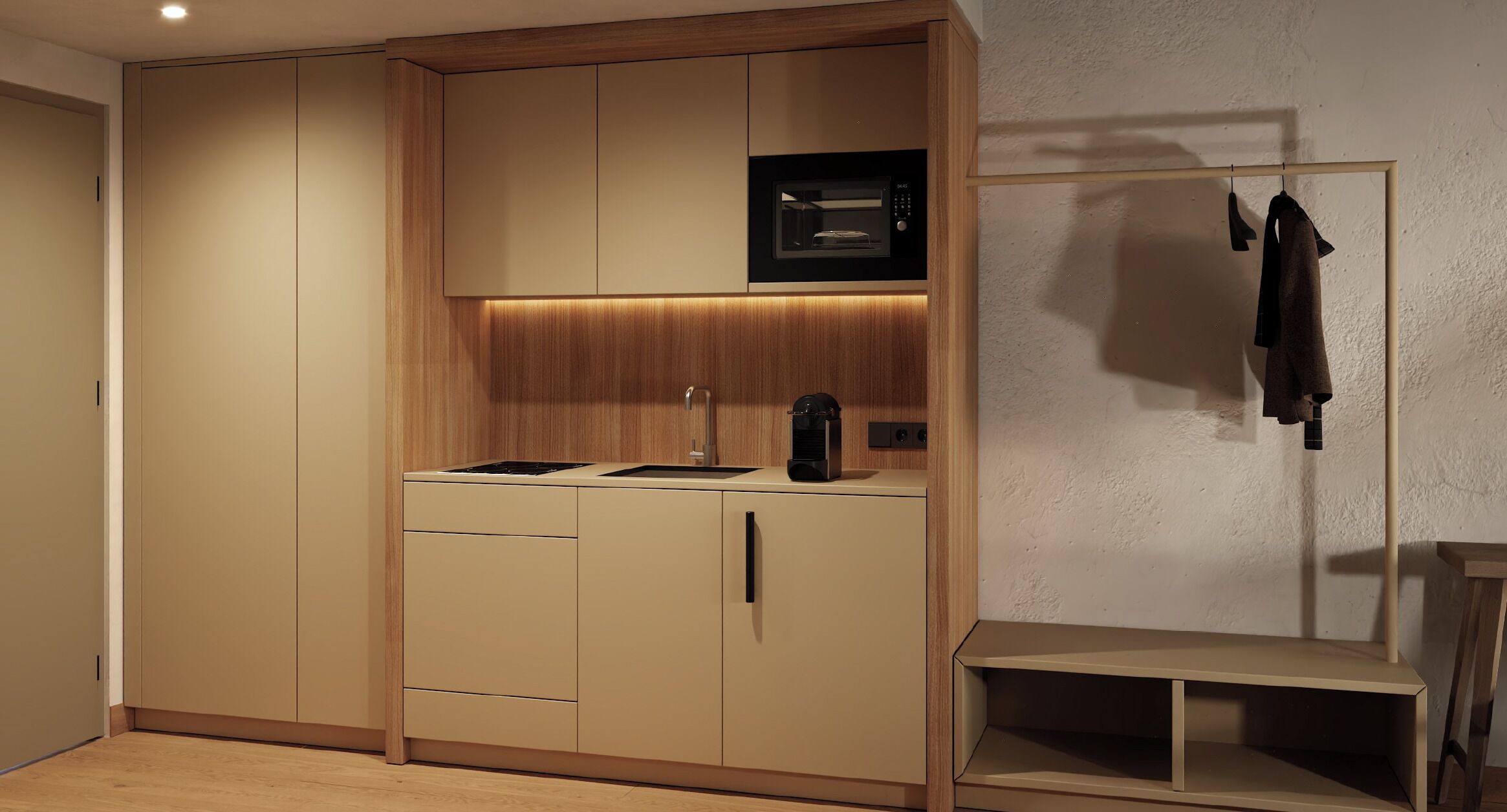 Une cuisine compacte dotée d’appareils électroménagers intégrés, d’un four à micro-ondes et d’un petit plan de travail.