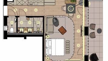 A hotel room layout with a bed, desk, chair, and a small seating area.