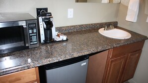 A kitchen with a microwave, coffee maker, and sink. - Gateway Inn (Lyman)