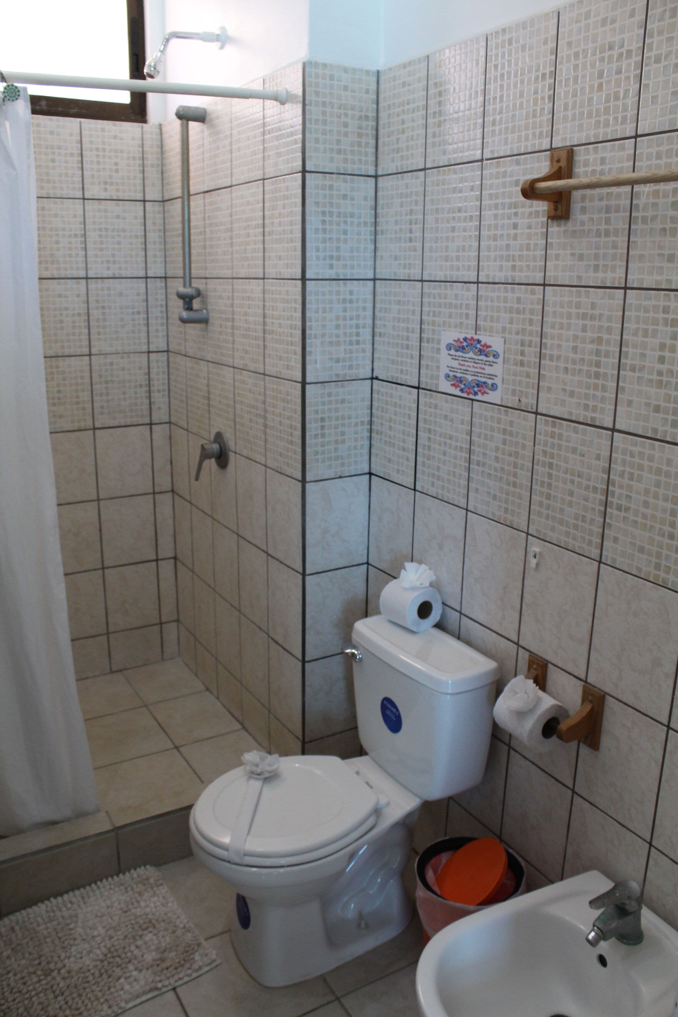 A bathroom with a toilet, bidet, and sink.