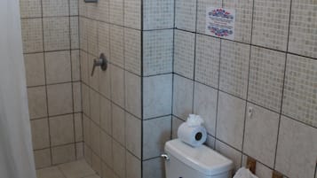 A bathroom with a toilet, bidet, and sink.
