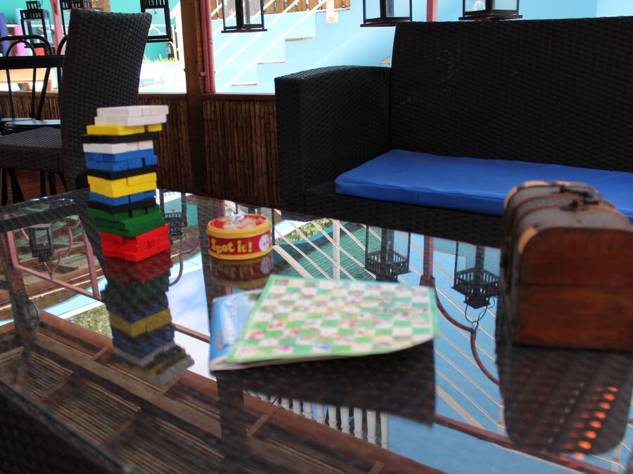 A glass table with a Rubik's cube, a board game, and a toy train.