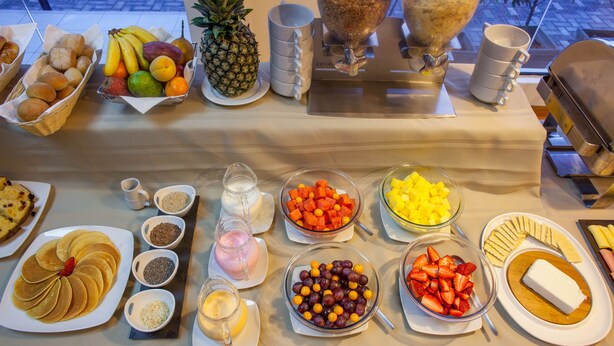 A buffet table with various food items and condiments. - Del Prado Hotel (Lima)