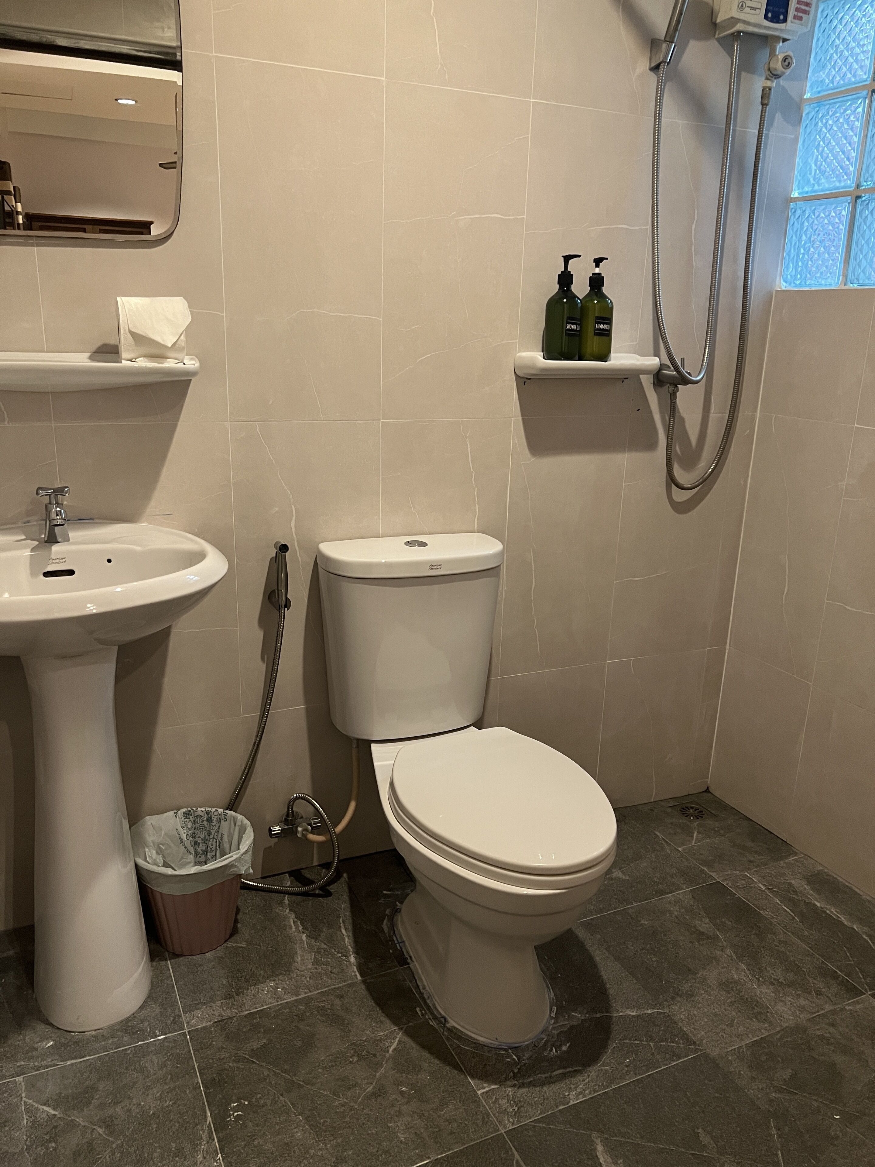 A bathroom with a sink, toilet, and shower.