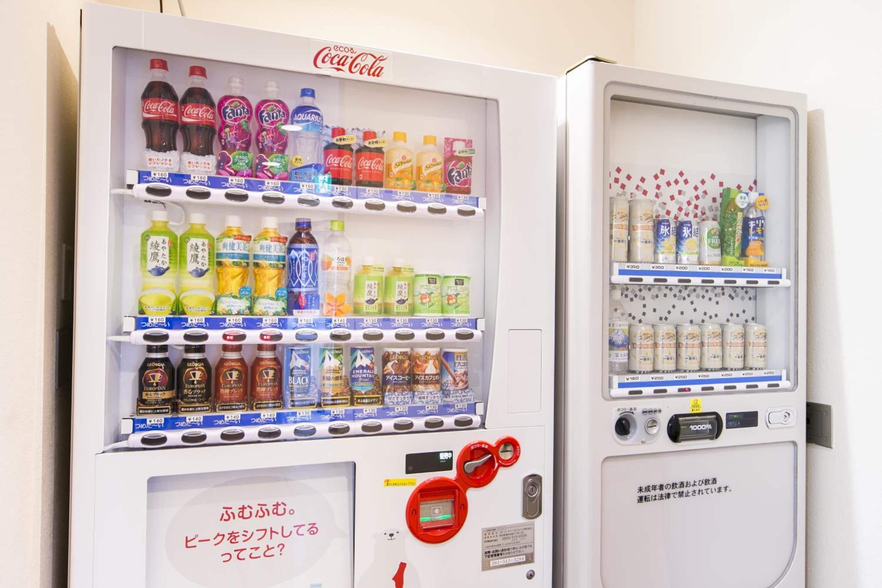 A vending machine with multiple beverage options, including Coca-Cola and Fanta.