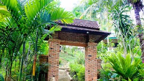 A brick staircase leading up to a covered area surrounded by lush greenery. - Aonang Cliff Mountain New Resort (Krabi)