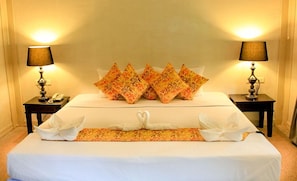 A neatly made bed with white linens and decorative pillows, two bedside lamps, and a telephone on a nightstand. - Aonang Cliff Mountain New Resort (Krabi)