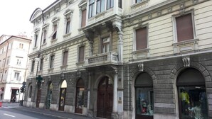 A historic building with ornate architectural details, including arched windows and decorative moldings. - Brilliant Camere (Trieste)