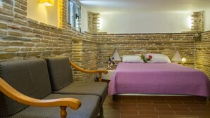 A room with a bed, a sofa, and a nightstand. - Corinthian Residence (Xylokastro-Evrostina)