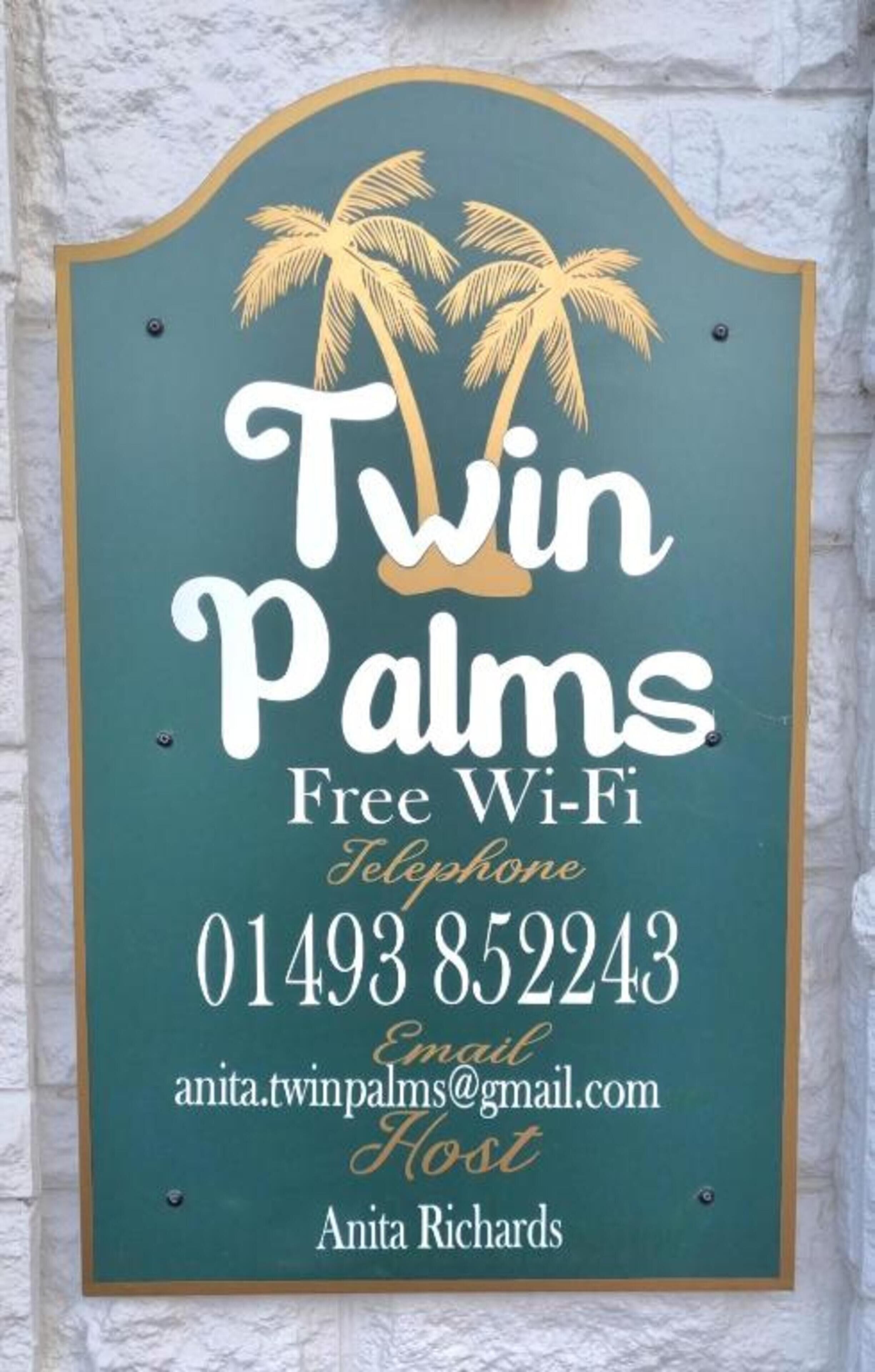 A sign for Twin Palms offering free Wi-Fi, a telephone number, and an email address for contact.
