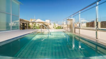 Outdoor pool, open 9:00 AM to 10:00 PM, pool umbrellas, pool loungers