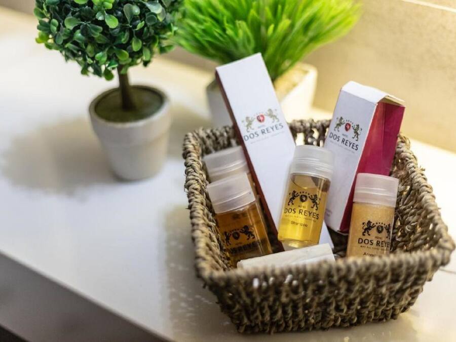 A wicker basket containing various Dos Reyes branded products on a countertop.