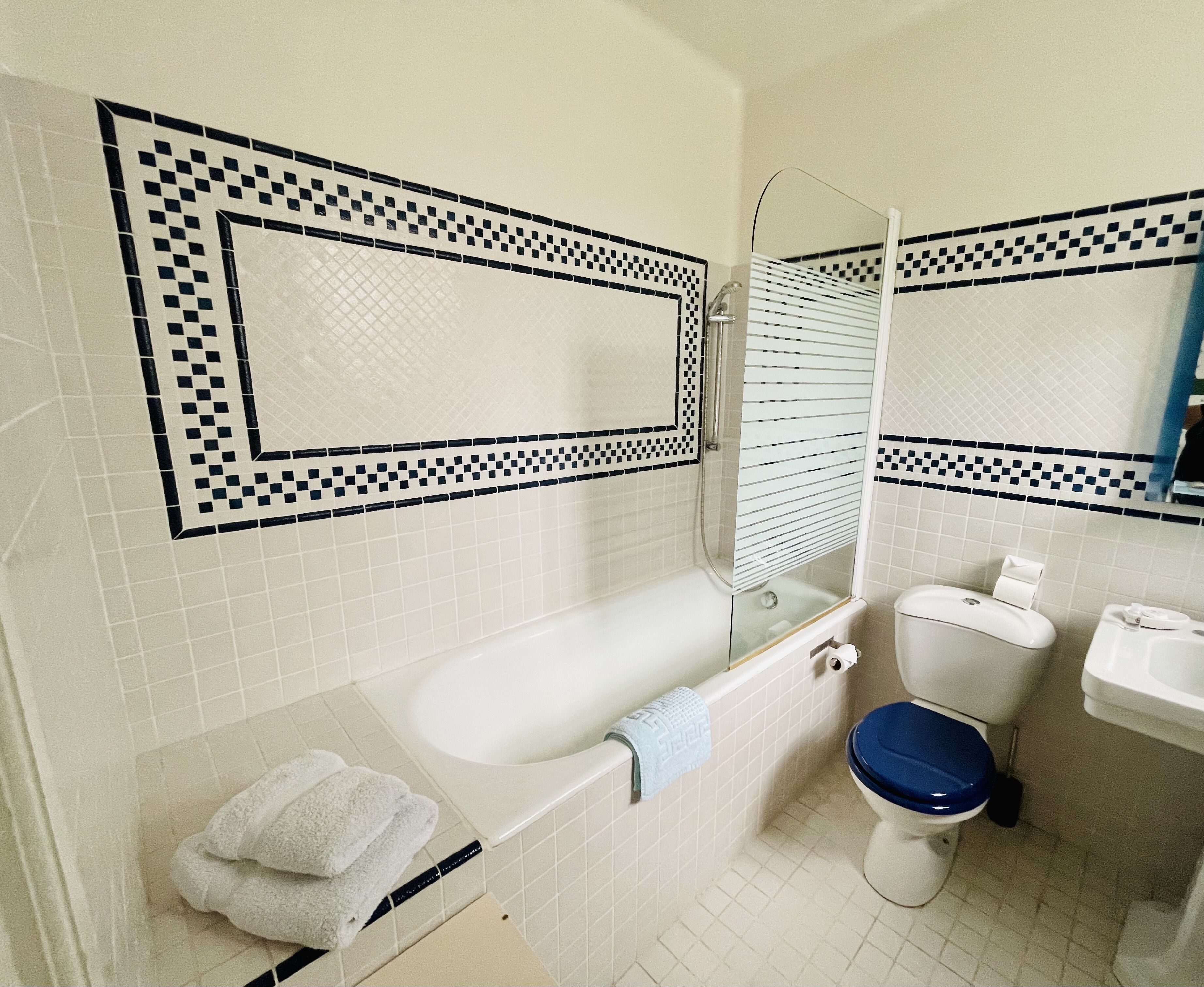 A bathroom with a bathtub, toilet, and sink.