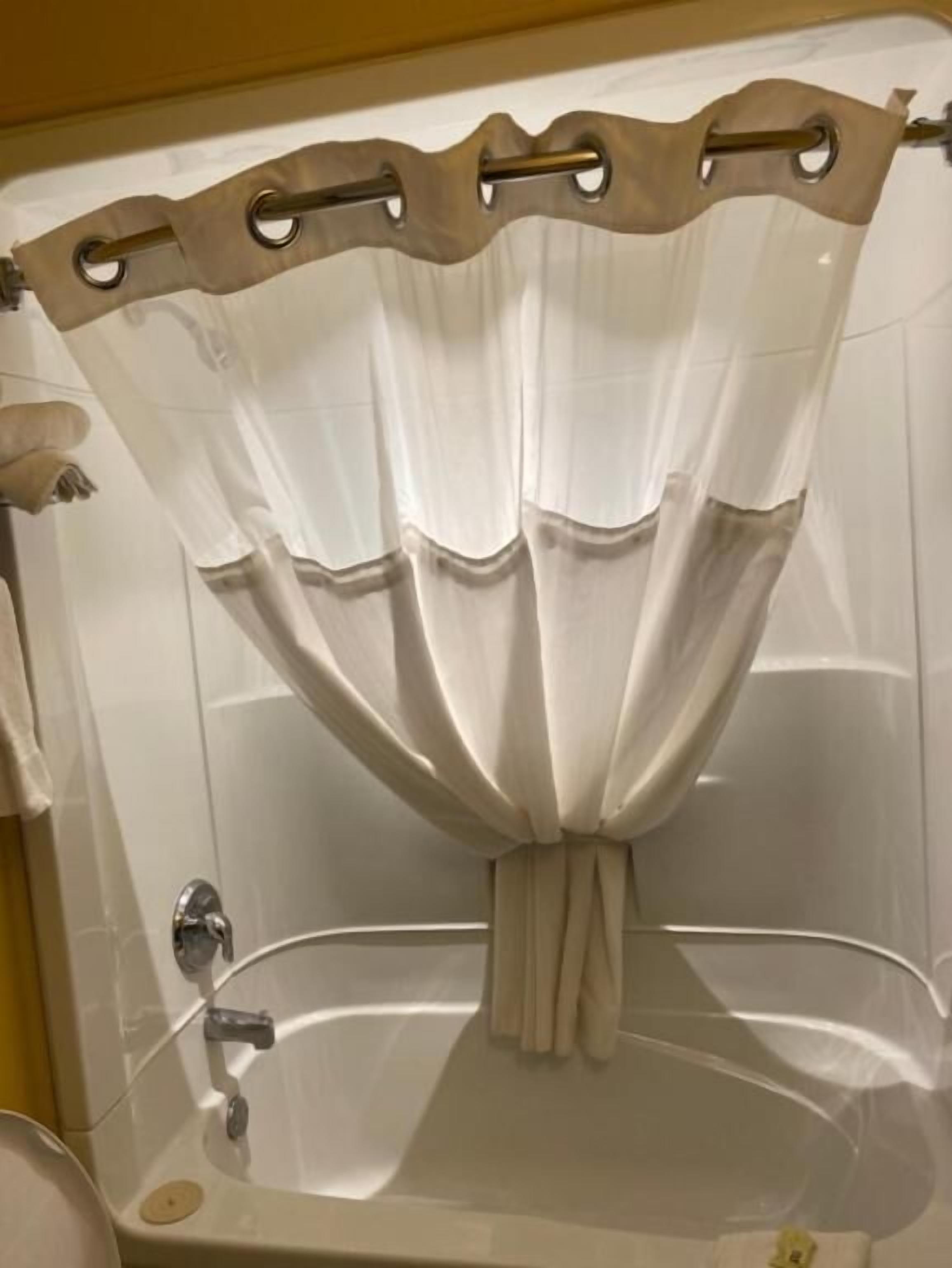 A bathroom with a bathtub, a shower, and a toilet.
